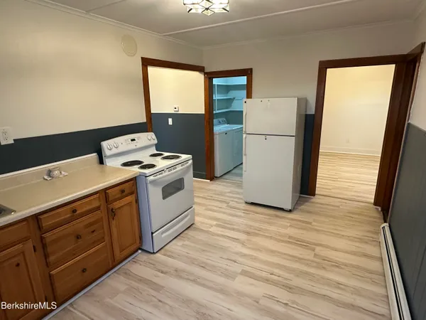 a kitchen with a stove and a refrigerator