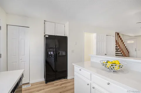 a kitchen with a refrigerator and a stove