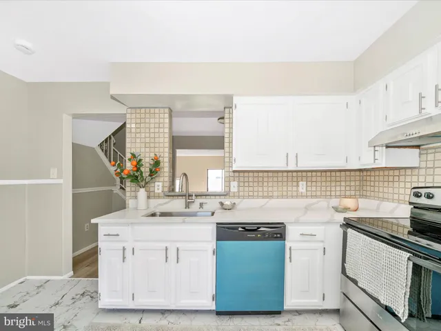 a kitchen with a refrigerator and a sink