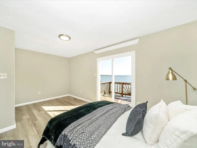 a view of a room with wooden floor and white walls