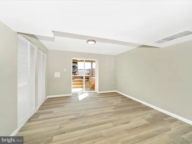 a view of a balcony with wooden floor and fence