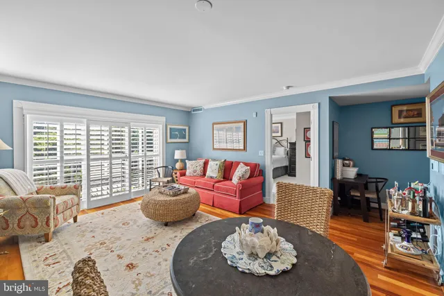 a view of a patio with table and chairs potted plants and large tree