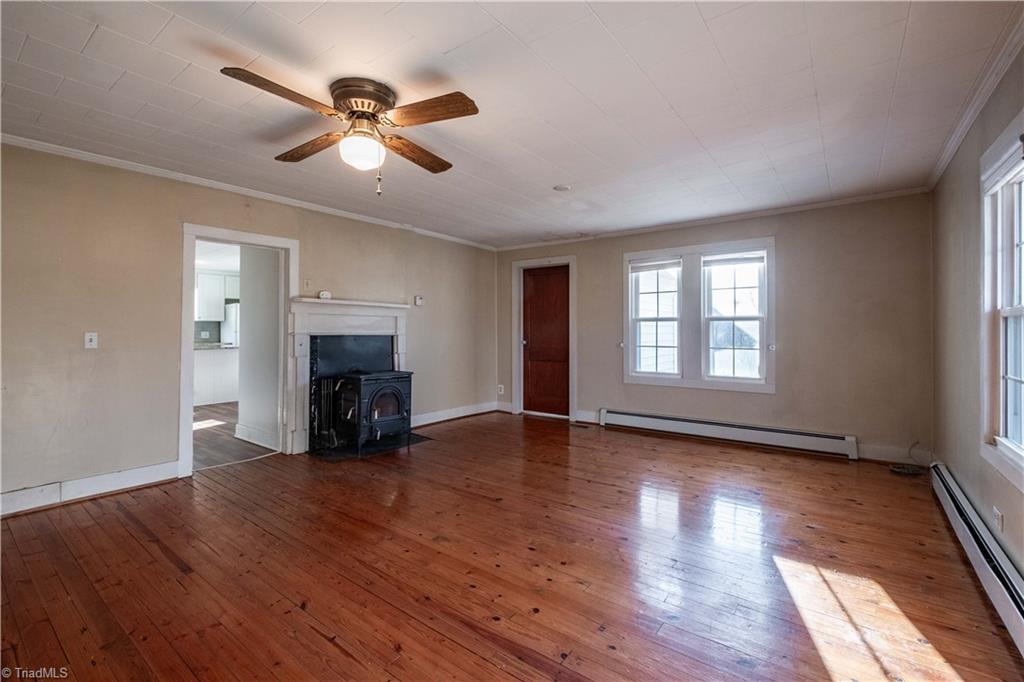 663 Ruritan Road Roaring River, NC 28669 - Photo 15 of 43 Living room looking toward kitchen and main level full bath and laundry room.
