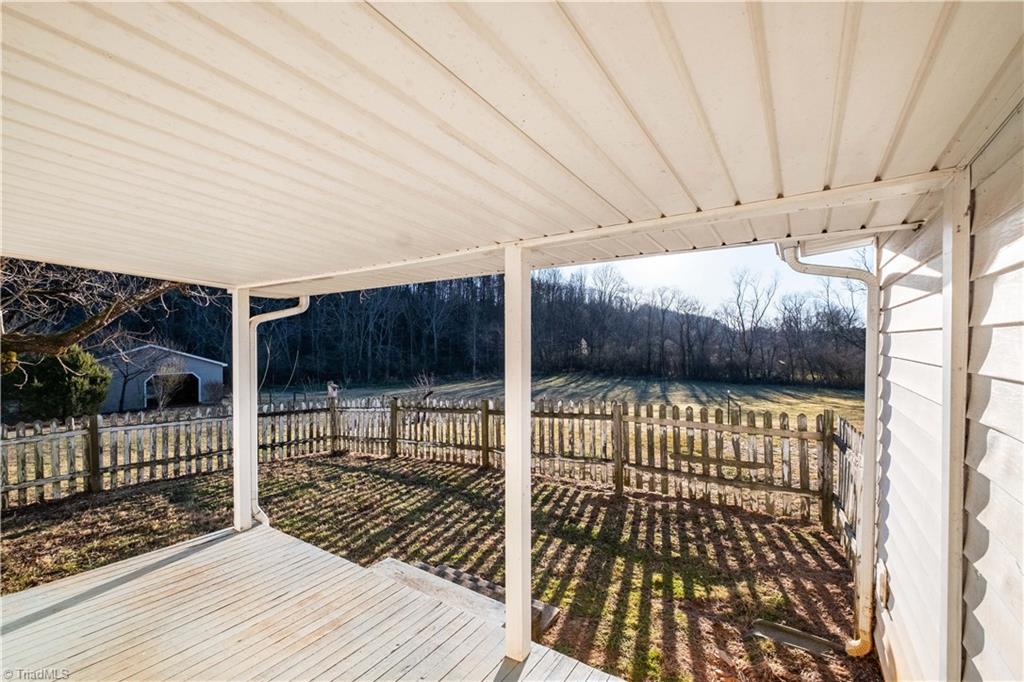 663 Ruritan Road Roaring River, NC 28669 - Photo 31 of 43 Covered side porch looking into fenced area.