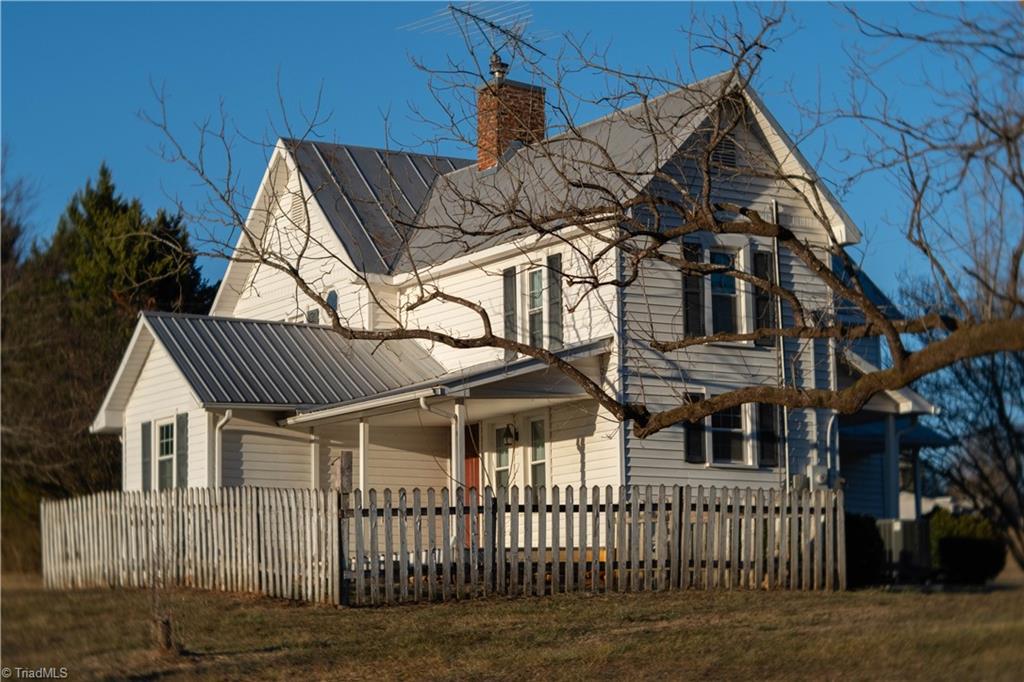 663 Ruritan Road Roaring River, NC 28669 - Photo 4 of 43 Rear view of home with picket fence.