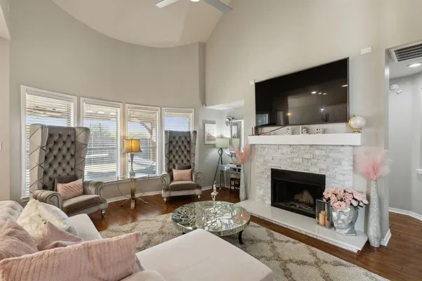 a living room with furniture a flat screen tv and a fireplace