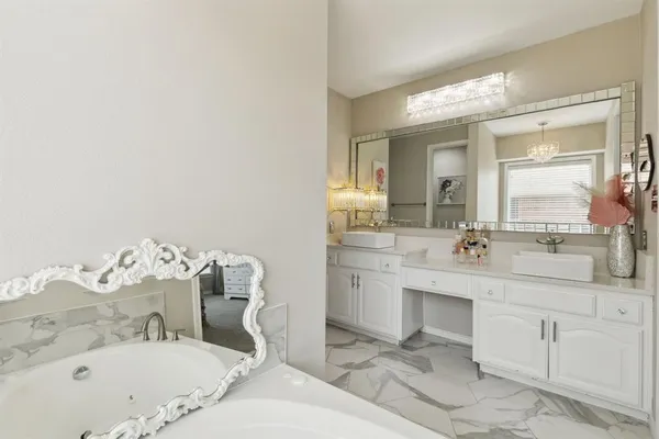 a en suite bathroom with a sink a mirror and a shower