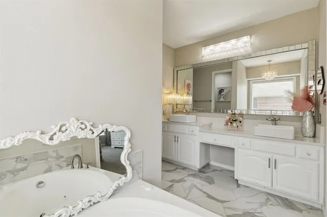 a en suite bathroom with a sink a mirror and a shower