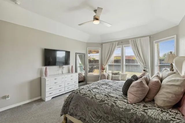 a bedroom with a bed and a chair