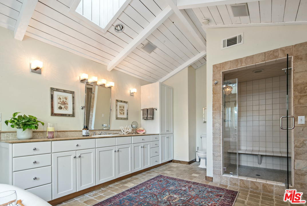 566 Stassi Lane Santa Monica, CA 90402 - Photo 11 of 26 a spacious bathroom with a double vanity sink a mirror and a shower