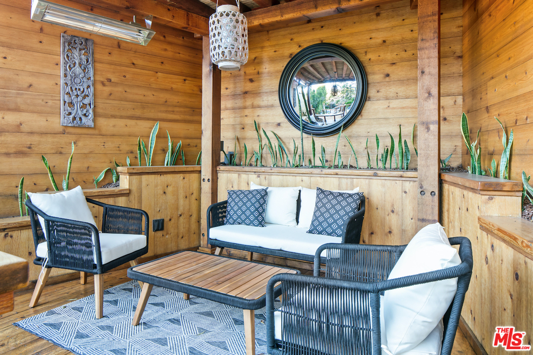 566 Stassi Lane Santa Monica, CA 90402 - Photo 26 of 26 a living room with furniture and a rug