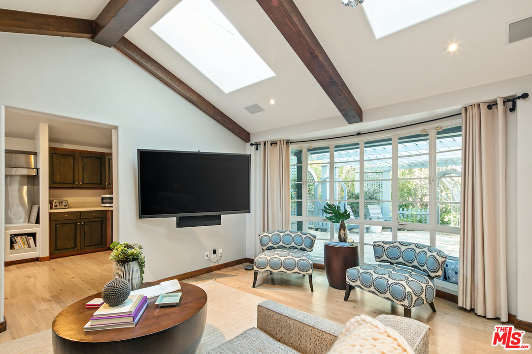 566 Stassi Lane Santa Monica, CA 90402 - Photo 5 of 26 a living room with furniture and a flat screen tv