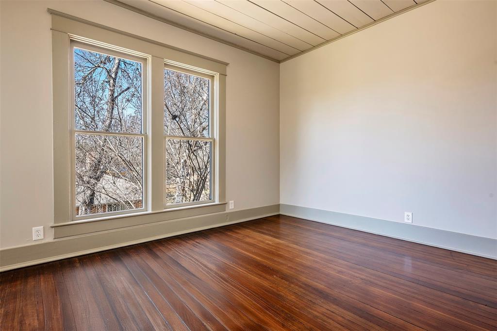 407 East Franklin Street Hillsboro, TX 76645 - Photo 13 of 16 a view of an empty room with wooden floor and a window