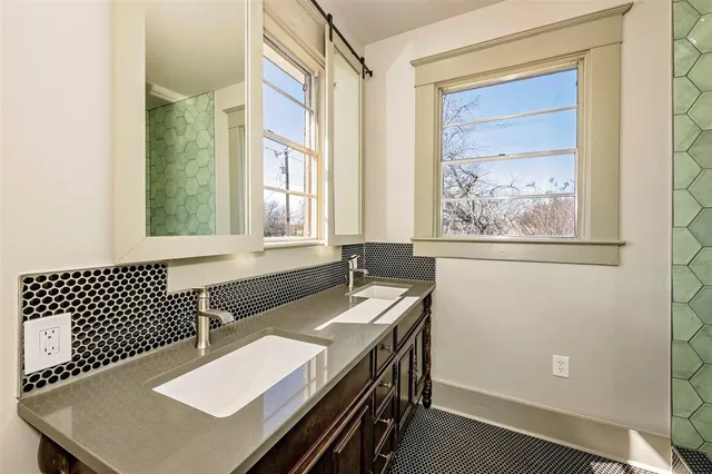 a bathroom with a sink a large mirror and a bathtub