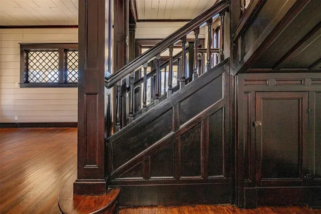 a view of staircase with wooden floor and a rug