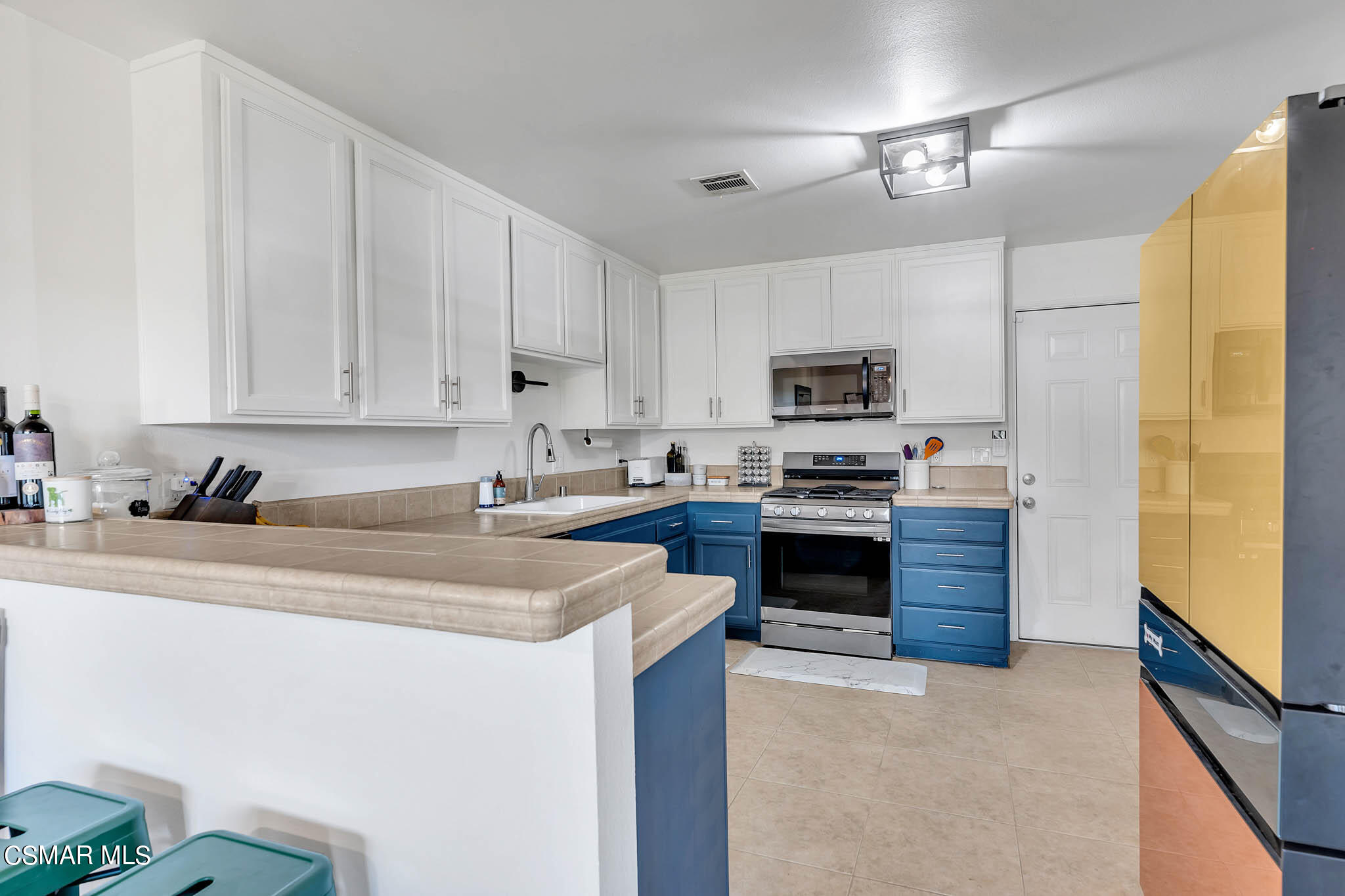 2586 Antonio Drive Camarillo, CA 93010 - Photo 6 of 37 a kitchen with granite countertop a stove top oven a sink a counter space and cabinets