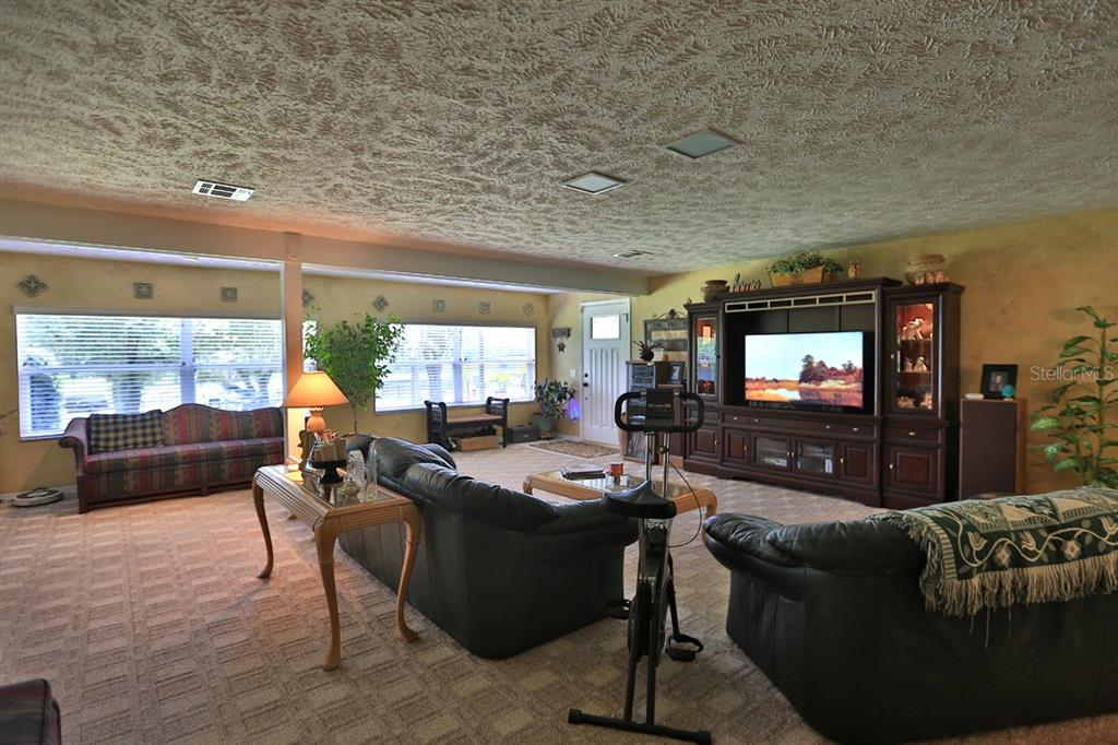 4888 Southwest 7th Avenue Road Ocala, FL 34471 - Photo 12 of 50 a living room with furniture and a flat screen tv