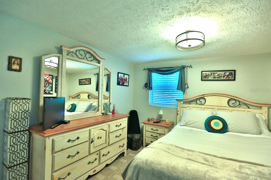 4888 Southwest 7th Avenue Road Ocala, FL 34471 - Photo 24 of 50 a bedroom with a bed and a dresser