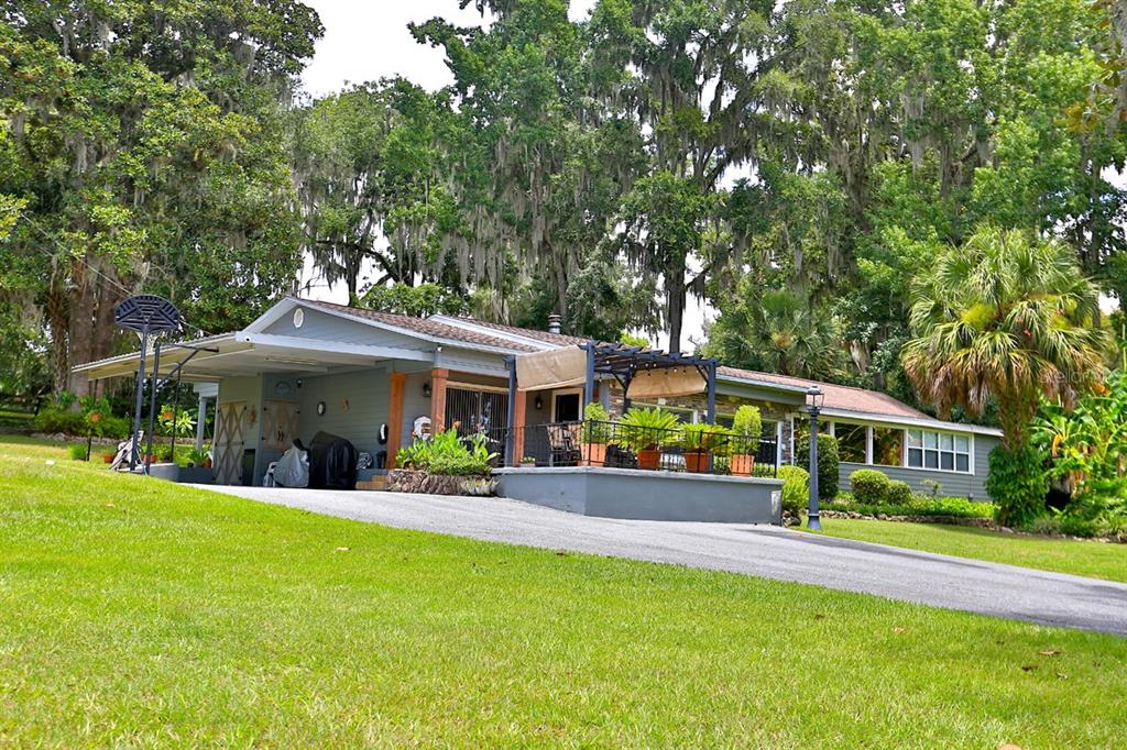4888 Southwest 7th Avenue Road Ocala, FL 34471 - Photo 33 of 50 a front view of a house with a yard table and chairs