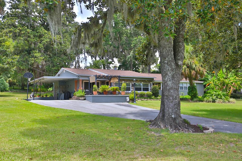 4888 Southwest 7th Avenue Road Ocala, FL 34471 - Photo 34 of 50 a view of a house with a yard porch and sitting area