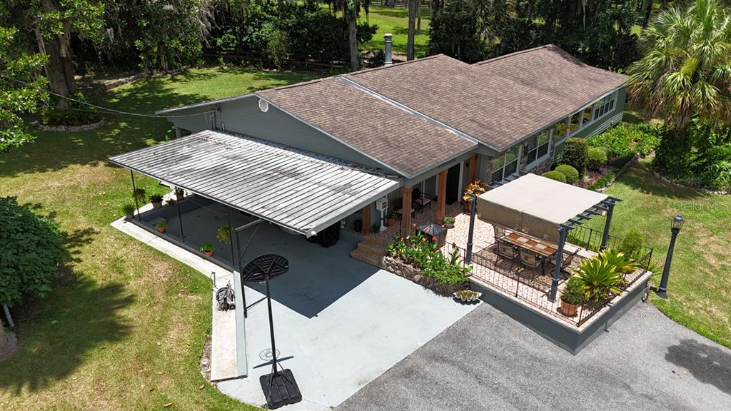 4888 Southwest 7th Avenue Road Ocala, FL 34471 - Photo 42 of 50 a terrace with a table and chairs a barbeque