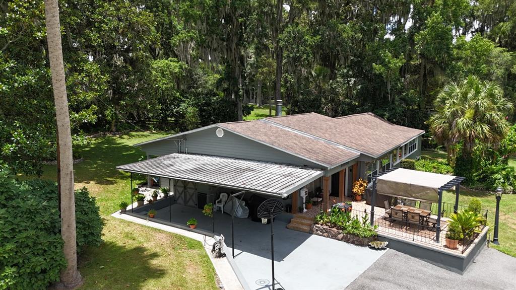 4888 Southwest 7th Avenue Road Ocala, FL 34471 - Photo 48 of 50 a terrace with outdoor seating and trees