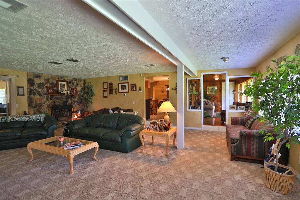 4888 Southwest 7th Avenue Road Ocala, FL 34471 - Photo 7 of 50 a living room with furniture and potted plants