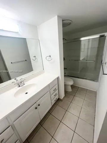 a spacious bathroom with a double vanity sink mirror and toilet