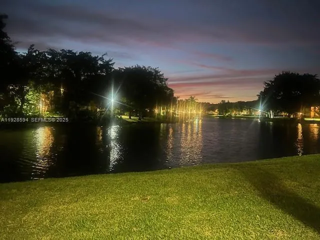a lake view with a big yard