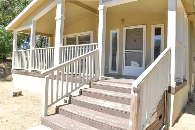a view of a house with wooden floor and fence