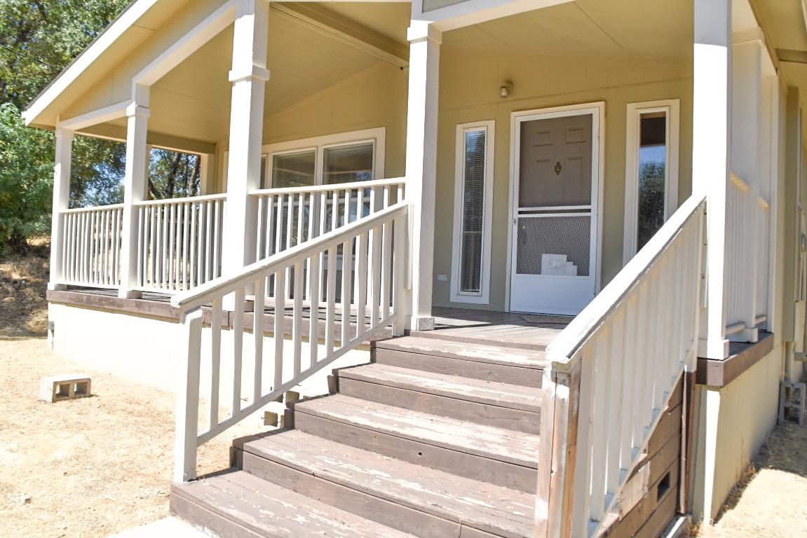 a view of a house with wooden floor and fence