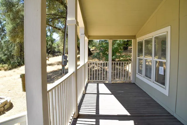 a view of a balcony with wooden floor