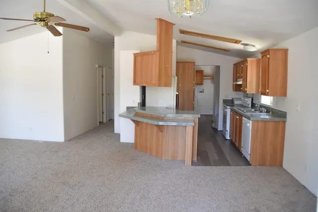 a view of kitchen with sink microwave and refrigerator