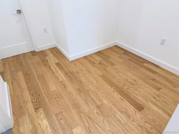 a view of a room with wooden floor