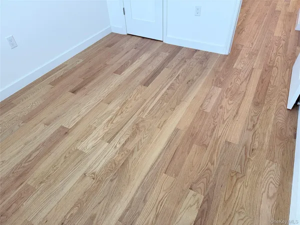 a view of a room with wooden floor