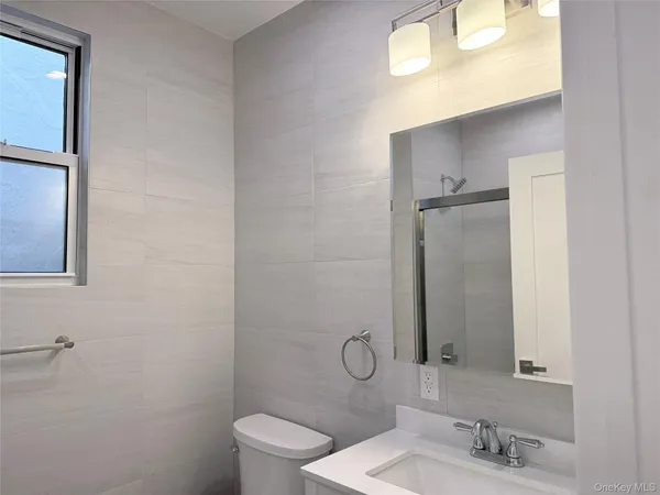 a bathroom with a glass shower door