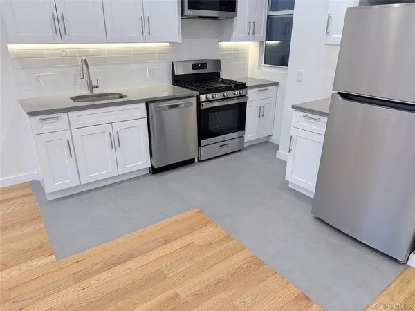 a kitchen with white cabinets and white appliances