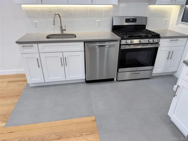 a kitchen with stainless steel appliances granite countertop a stove and a sink