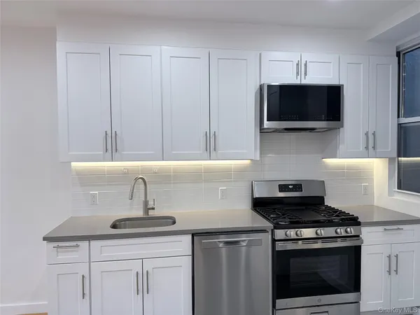 a kitchen with a stove and a microwave