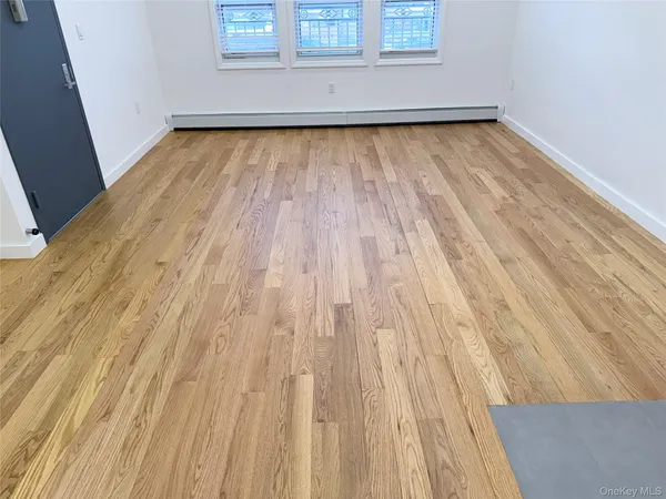 a view of a room with wooden floor and window