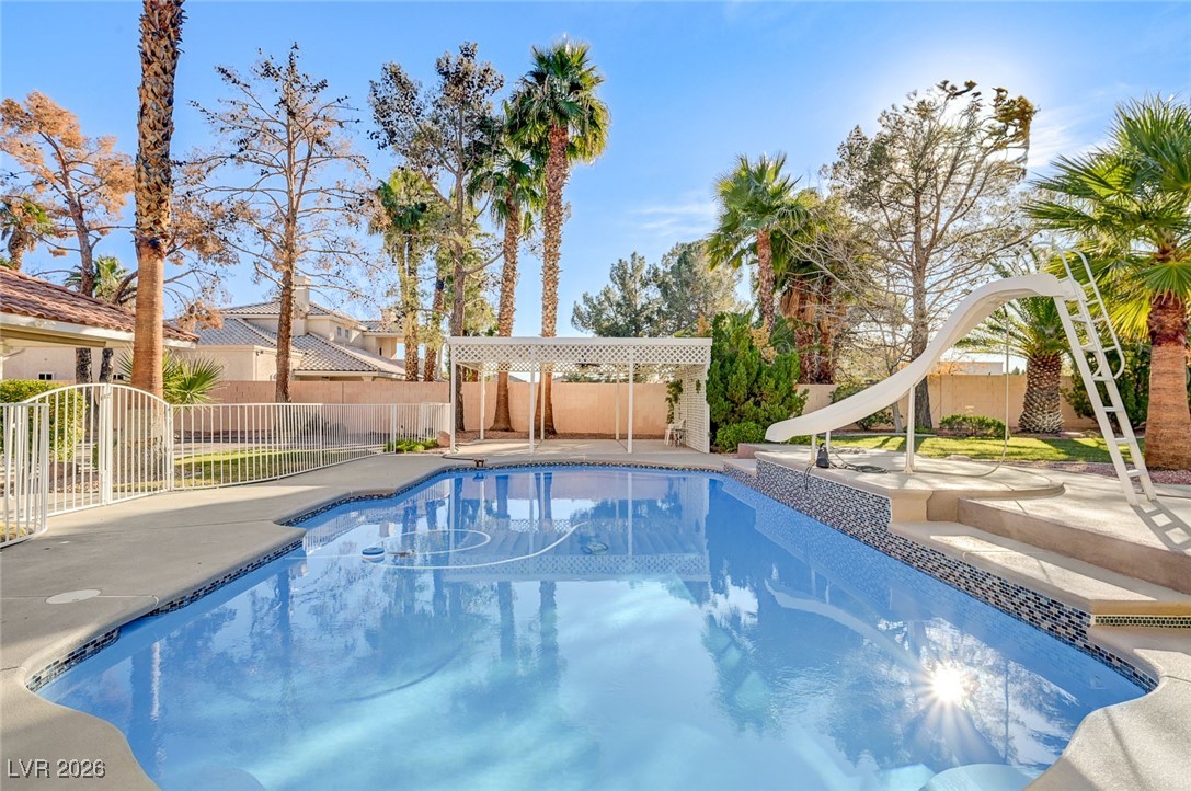 2955 El Camino Road Las Vegas, NV 89146 - Photo 88 of 99 View of pool featuring a fenced backyard, a water slide, and a patio