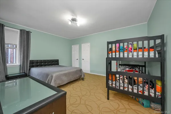 a bedroom with bed and a window