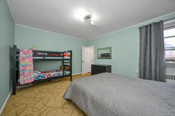 a bedroom with a bed and a tv