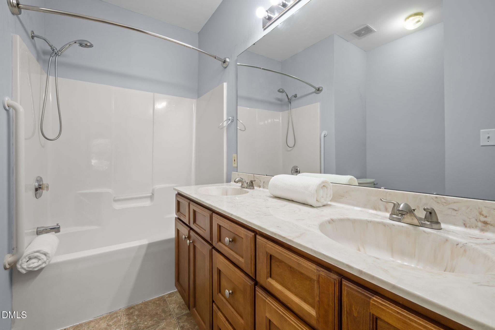 4211 Holston Drive Durham, NC 27704 - Photo 17 of 33 a bathroom with a granite countertop sink mirror double vanity and bathtub