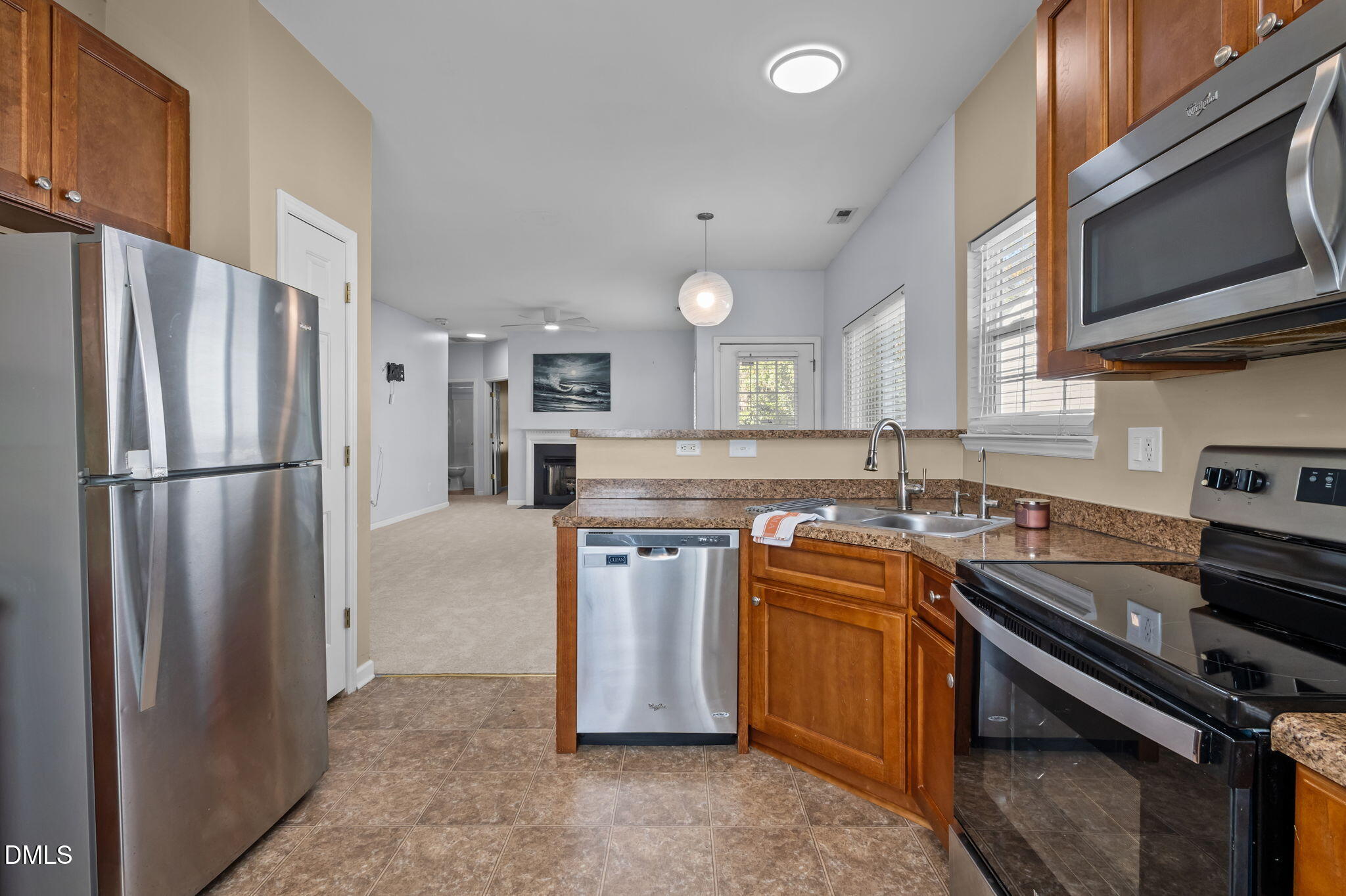 4211 Holston Drive Durham, NC 27704 - Photo 8 of 33 a kitchen with stainless steel appliances granite countertop a stove a refrigerator and a sink
