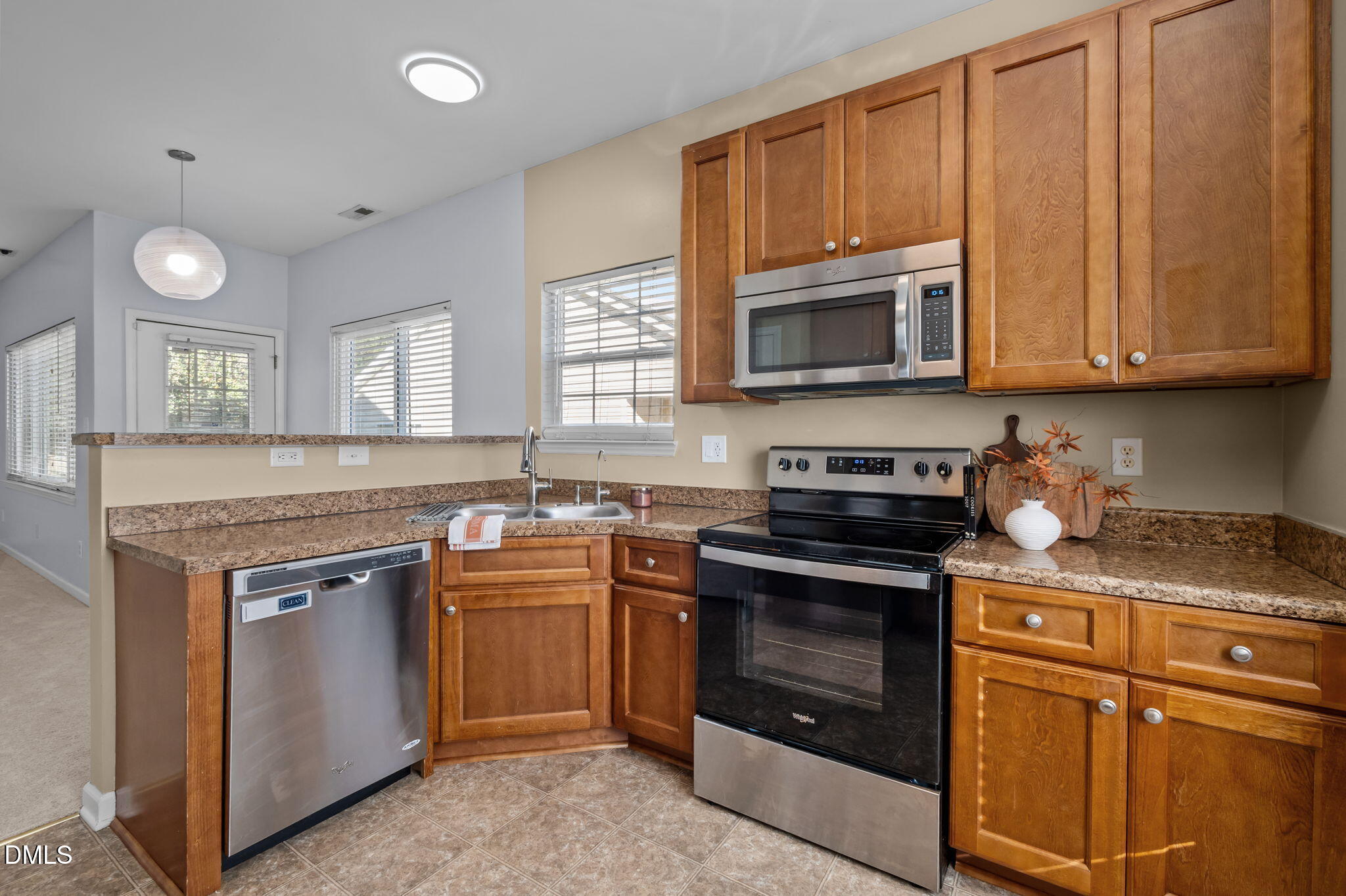 4211 Holston Drive Durham, NC 27704 - Photo 9 of 33 a kitchen with granite countertop cabinets stainless steel appliances and a sink