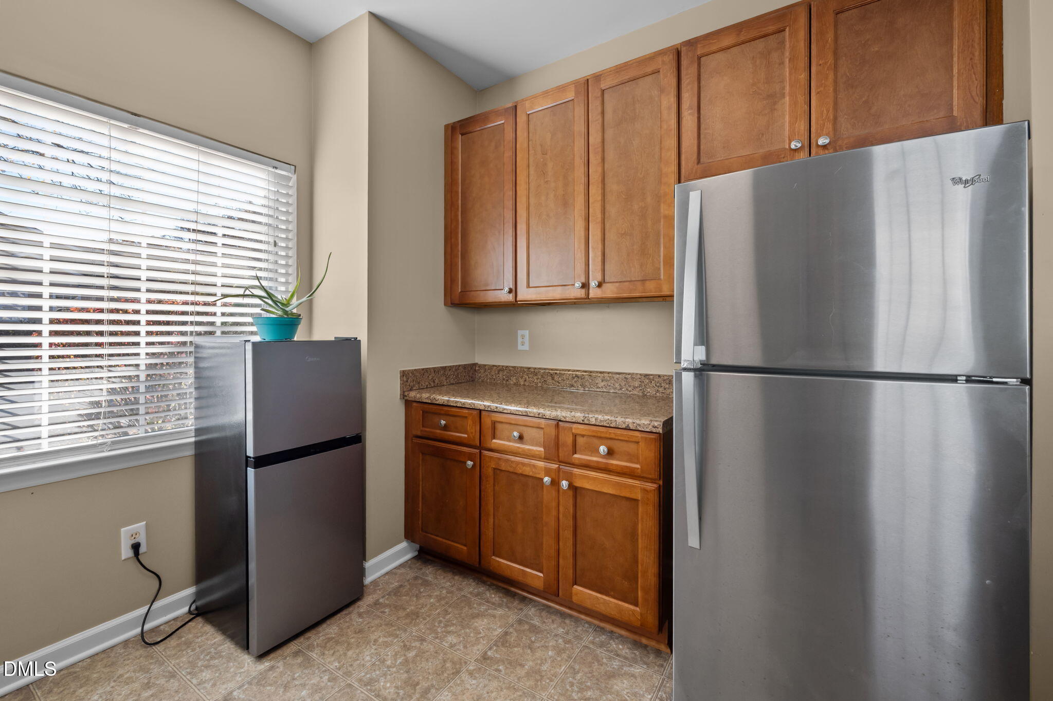 4211 Holston Drive Durham, NC 27704 - Photo 10 of 33 a kitchen with stainless steel appliances granite countertop a refrigerator and a sink