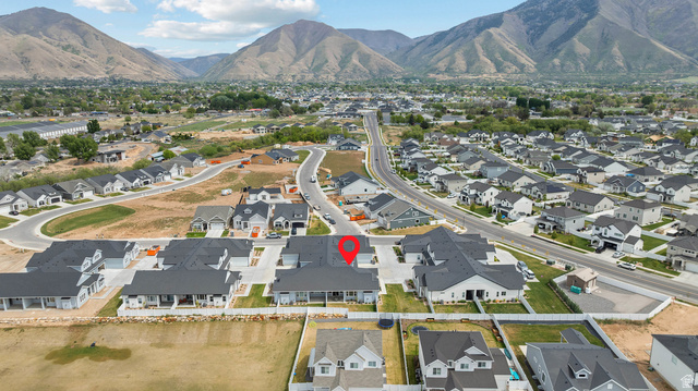 531 North Legend Way West, Unit D Mapleton, UT 84664 - Photo 37 of 42 Aerial view of residential area featuring a mountain backdrop