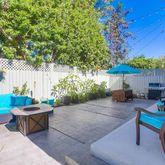 a backyard of a house with a table and chairs