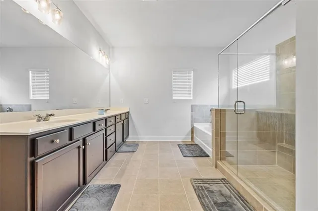 a bathroom with a sink a mirror and a shower